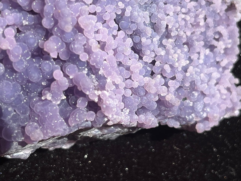 close up of the large and small grape formations on the amethyst cluster