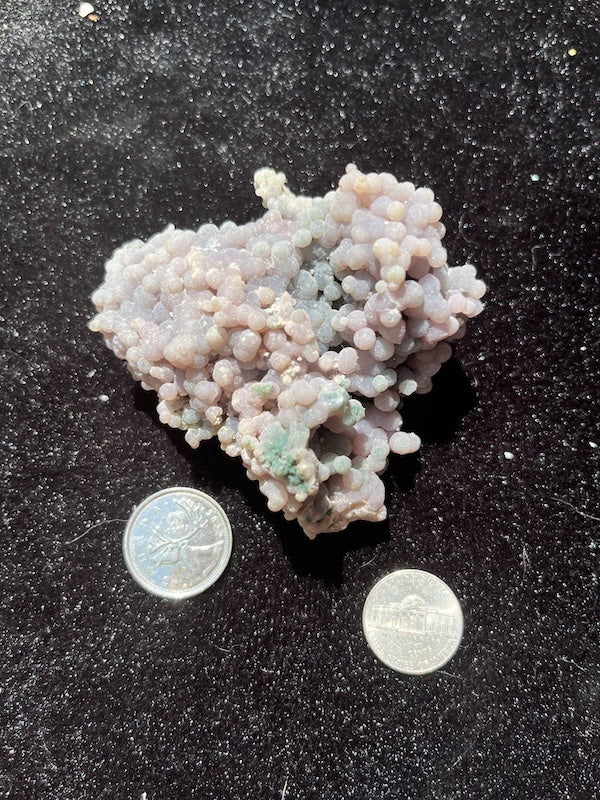 Pastel colors on grape agate cluster shown with coins for size comparison