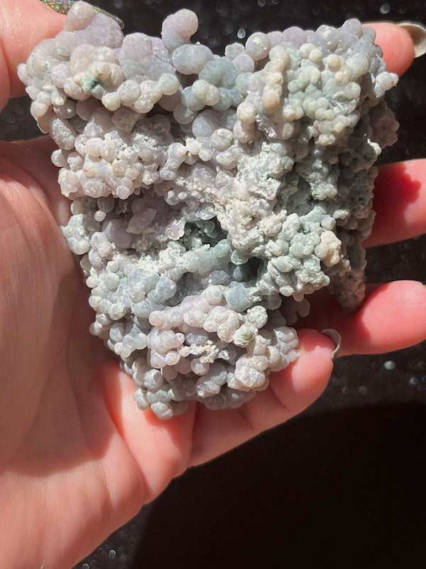 Green and turquoise run through the back of this grape agate cluster