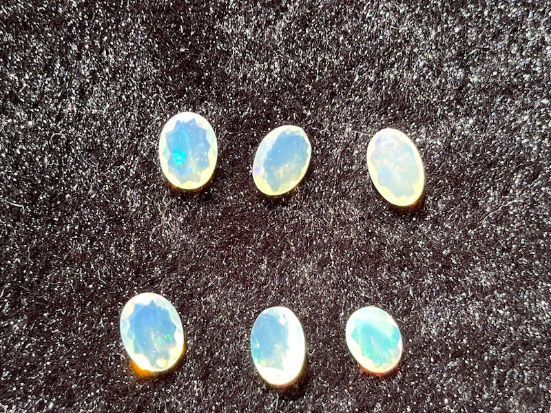 Faceted Opals, oval, pink, blue and yellow flash.