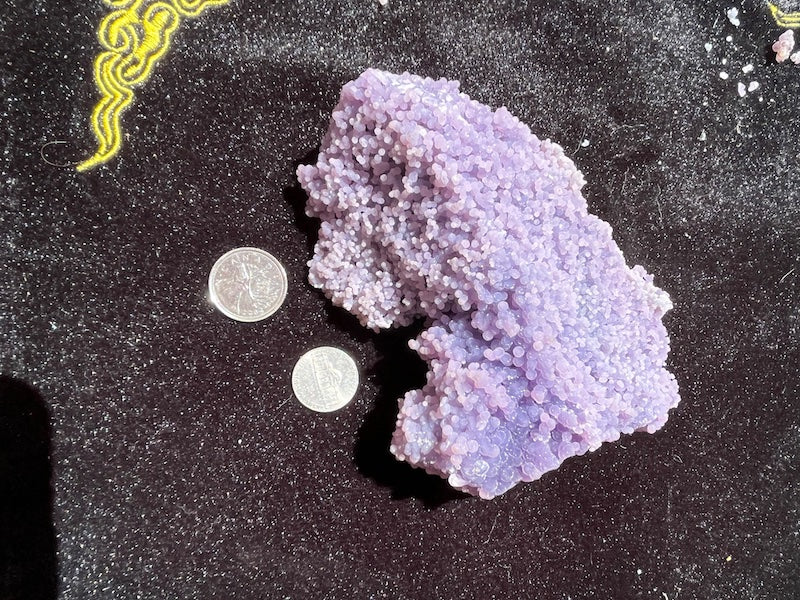 Size comparison of the grape agate cluster to a Canadian quarter and an American nickel