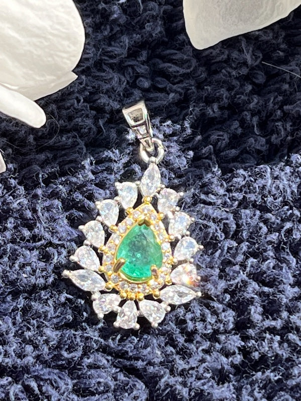 Pendant, Natural Sparkling Emerald with cz accent set in sterling silver.