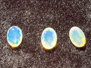 Faceted Opals, oval, pink, blue and yellow flash.