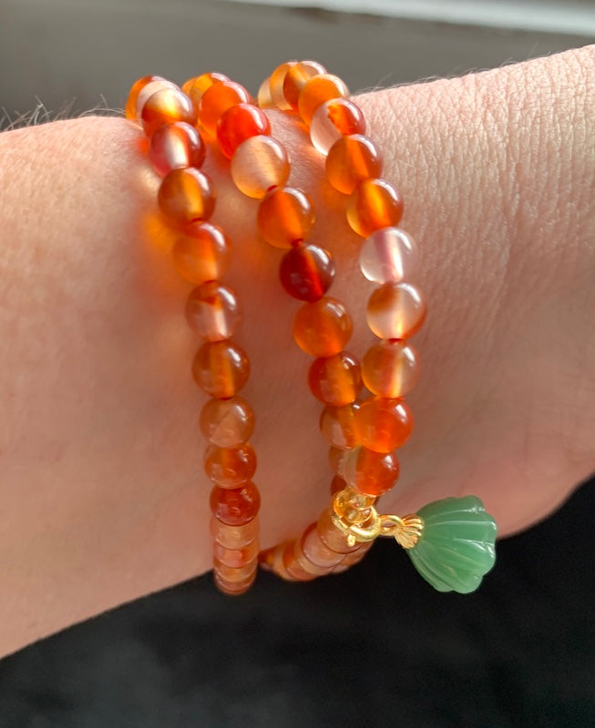 Bracelet, carnelian beads, 3 laps with jade lotus flower.