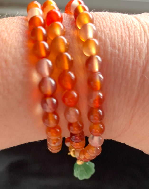 Bracelet, carnelian beads, 3 laps with jade lotus flower.