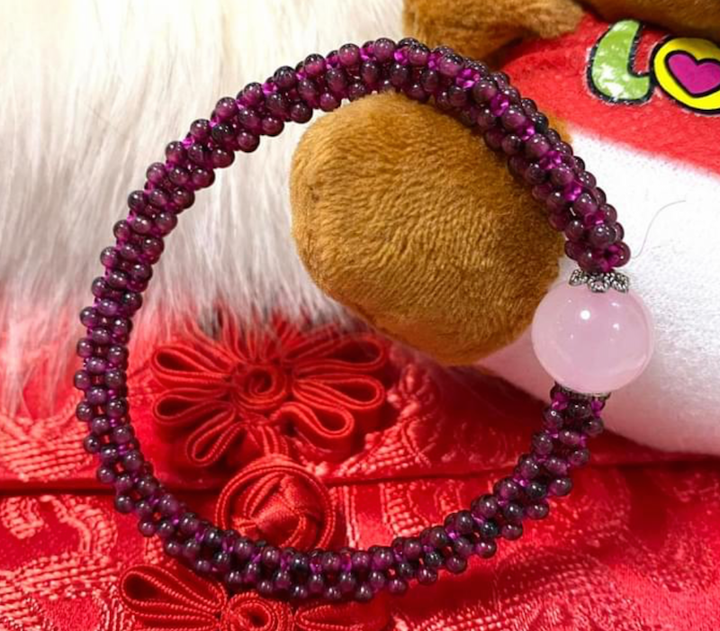 Bracelet, garnet beads with rose quartz focal bead